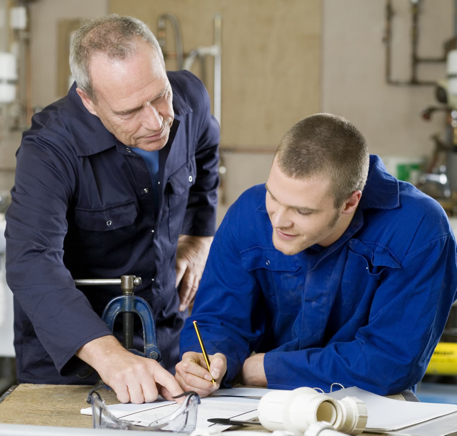 Plumber helping a new recruit
