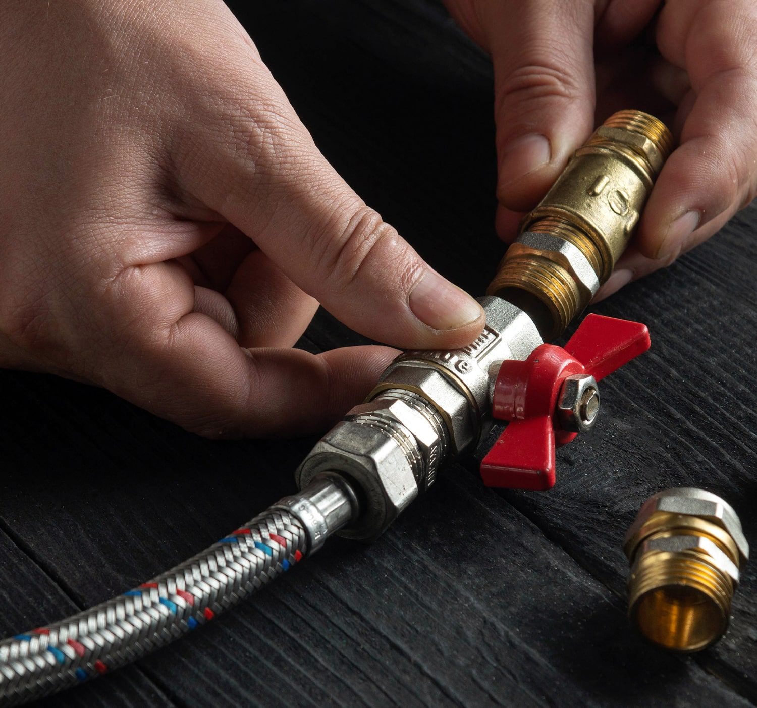 Plumber working with hoses