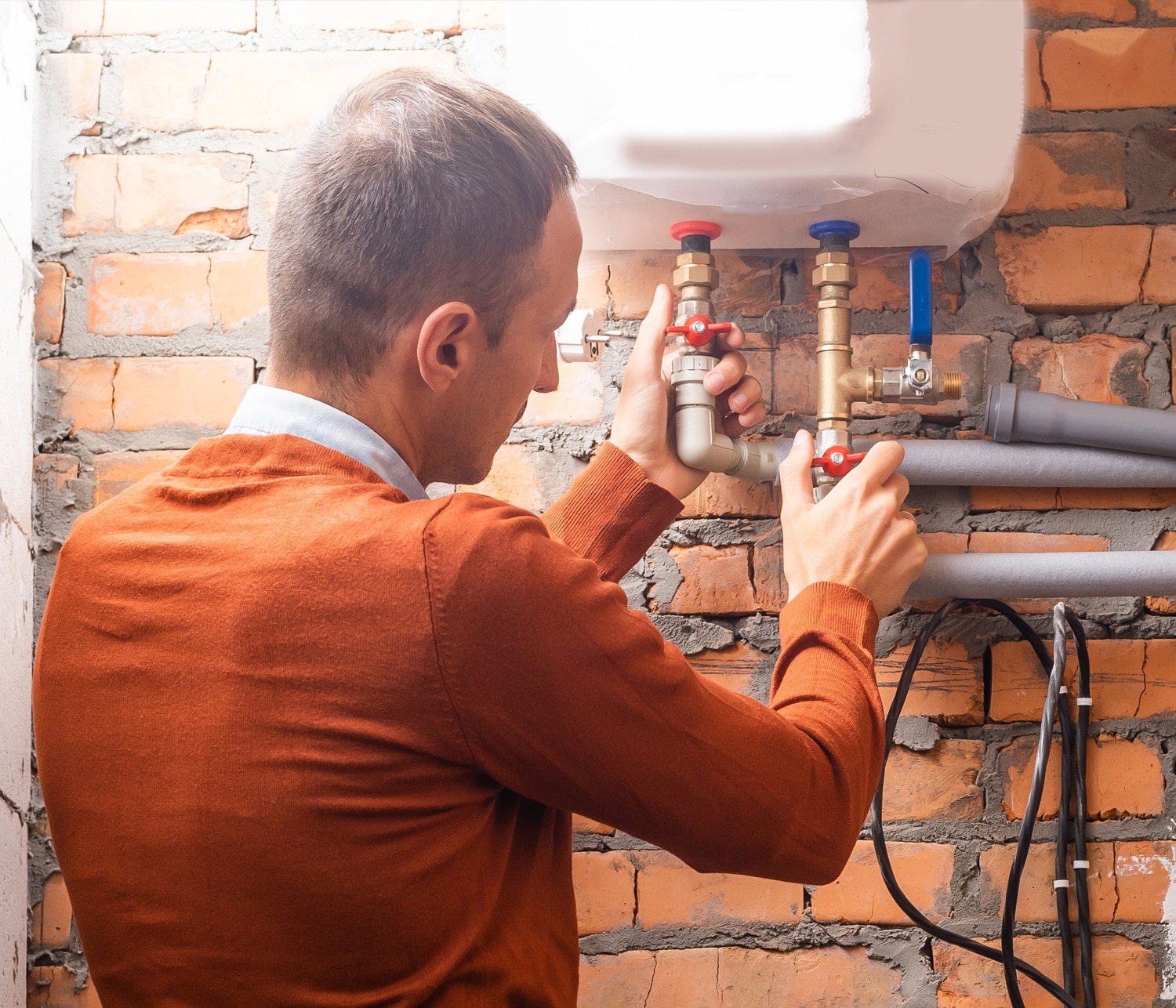 Plumber fixing pipes
