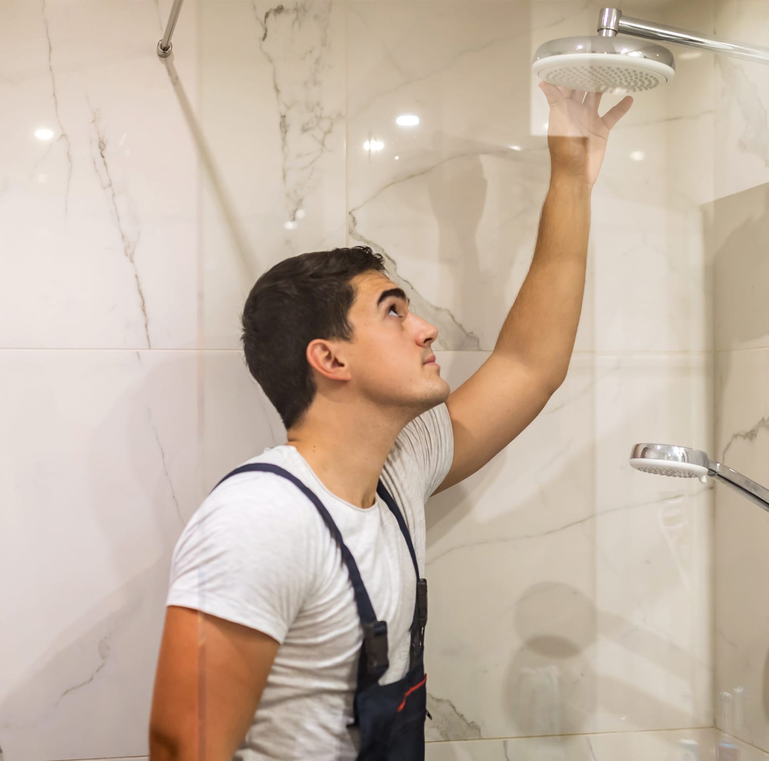 Plumber installing a rain showerhead