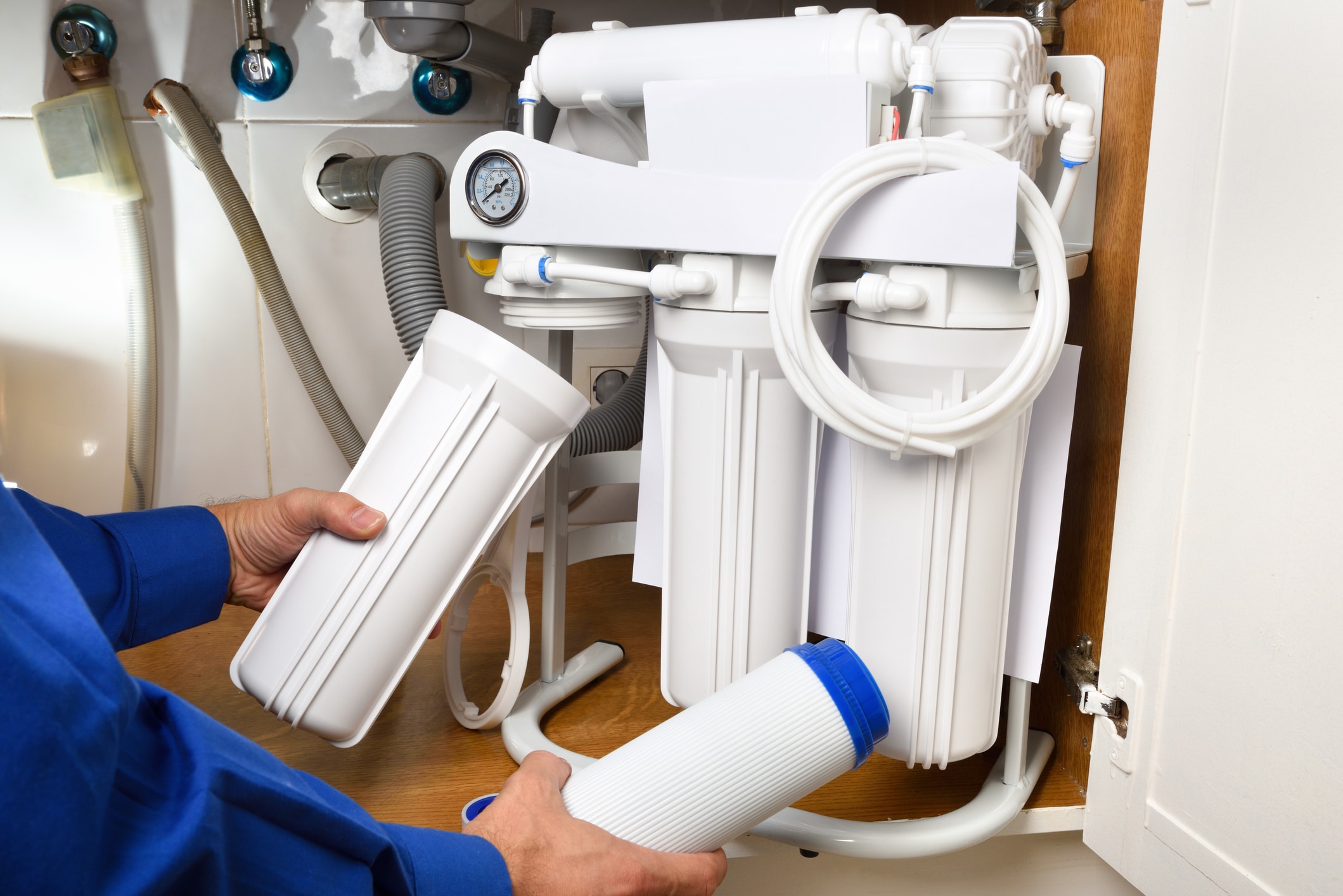 A plumber working on a water softener