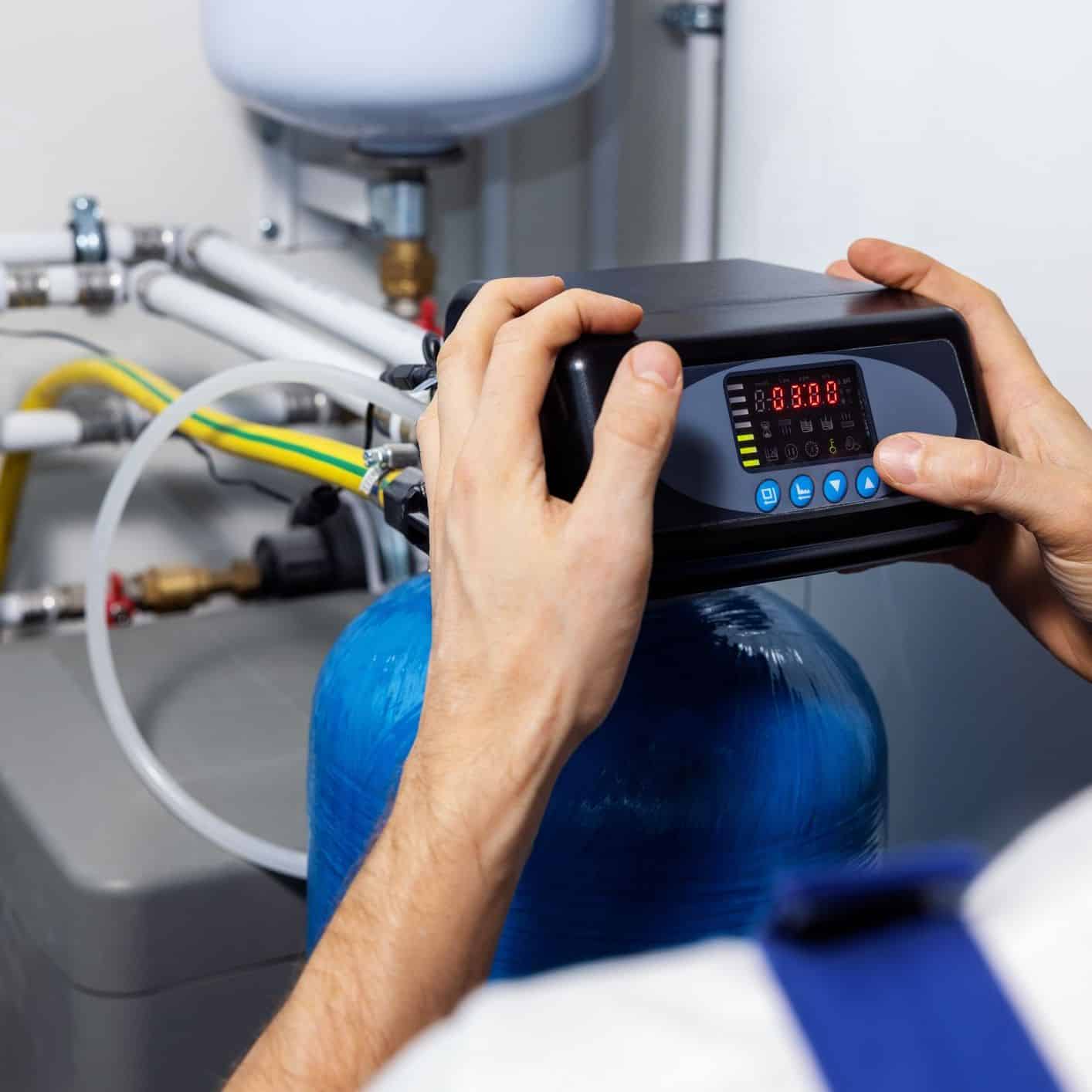 A plumber inspecting a water softener