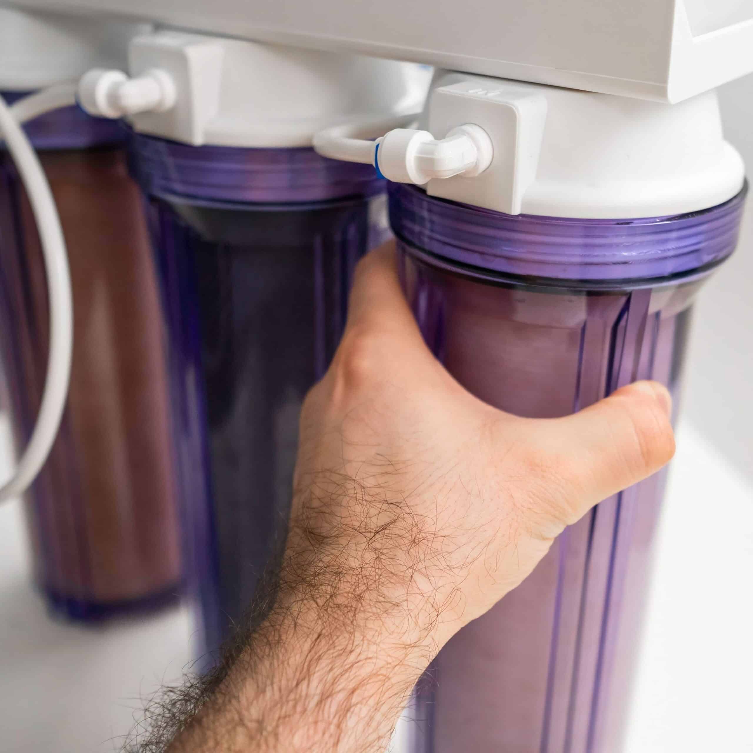 A plumber inspecting a water softener